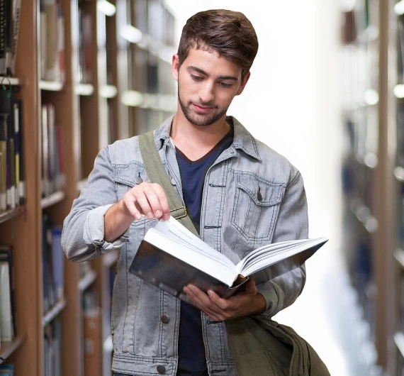 Student reading a French book while preparing for the DELF exam
